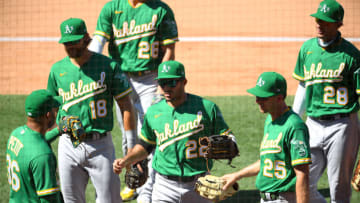 ANAHEIM, CA - AUGUST 12: Ramon Laureano #22 is congratulated as he returns to the dugout after reaching over the wall for a ball hit by Brian Goodwin #18 of the Los Angeles Angels in the eighth inning of the game at Angel Stadium of Anaheim on August 12, 2020 in Anaheim, California. (Photo by Jayne Kamin-Oncea/Getty Images)