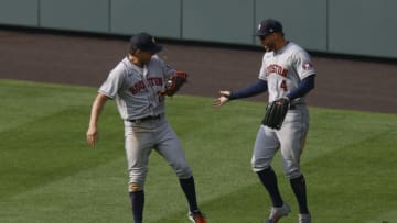DENVER, CO - AUGUST 20: Josh Reddick #22 of the Houston Astros is congratulated by George Springer #4 after making a diving catch to end the game in the ninth inning at Coors Field on August 20, 2020 in Denver, Colorado. The Astros defeated the Rockies for the fourth straight game, winning 10-8. (Photo by Justin Edmonds/Getty Images)