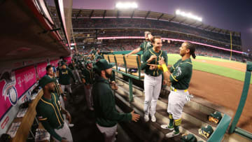 ANAHEIM, CALIFORNIA - SEPTEMBER 24: Matt Olson #28 and Khris Davis #2 of the Oakland Athletics go through their pre-game ritual in the dugout prior to their MLB game against the Los Angeles Angels at Angel Stadium of Anaheim on September 24, 2019 in Anaheim, California. The Angels defeated the Athletics 3-2. (Photo by Victor Decolongon/Getty Images)