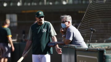 OAKLAND, CA - JULY 9: Manager Bob Melvin #6 and Executive Vice President of Baseball Operations Billy Beane of the Oakland Athletics talk on the field during summer workouts at RingCentral Coliseum on July 9, 2020 in Oakland, California. (Photo by Michael Zagaris/Oakland Athletics/Getty Images)