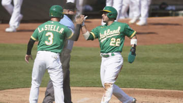 OAKLAND, CALIFORNIA - SEPTEMBER 30: Tommy La Stella #3 and Ramon Laureano #22 of the Oakland Athletics celebrate after they both scored against the Chicago White Sox during the first inning of Game Two of the American League Wild Card Round at RingCentral Coliseum on September 30, 2020 in Oakland, California. (Photo by Thearon W. Henderson/Getty Images)