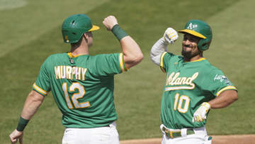 OAKLAND, CALIFORNIA - SEPTEMBER 30: Marcus Semien #10 and Sean Murphy #12 of the Oakland Athletics celebrates after Semien hit a two-run home run against the Chicago White Sox during the second inning of Game Two of the American League Wild Card Round at RingCentral Coliseum on September 30, 2020 in Oakland, California. (Photo by Thearon W. Henderson/Getty Images)