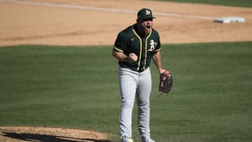 LOS ANGELES, CALIFORNIA - OCTOBER 07: Liam Hendriks #16 of the Oakland Athletics reacts to striking out Josh Reddick #22 of the Houston Astros to end the eighth inning in Game Three of the American League Division Series at Dodger Stadium on October 07, 2020 in Los Angeles, California. (Photo by Kevork Djansezian/Getty Images)