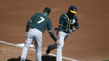 SCOTTSDALE, ARIZONA - MARCH 16: Jed Lowrie #8 of the Oakland Athletics celebrates with third base coach Mark Kotsay #7 after hitting a home run against the Arizona Diamondbacks during the fourth inning of the MLB spring training baseball game at Salt River Fields at Talking Stick on March 16, 2021 in Scottsdale, Arizona. (Photo by Ralph Freso/Getty Images)