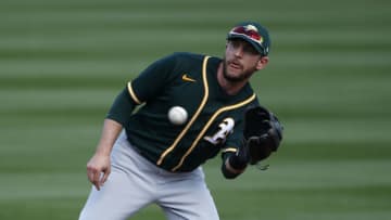 SCOTTSDALE, ARIZONA - MARCH 16: Second baseman Jed Lowrie #8 of the Oakland Athletics fields a throw to second during the second inning of the MLB spring training baseball game against the Arizona Diamondbacks at Salt River Fields at Talking Stick on March 16, 2021 in Scottsdale, Arizona. (Photo by Ralph Freso/Getty Images)