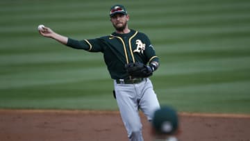 SCOTTSDALE, ARIZONA - MARCH 16: Second baseman Jed Lowrie #8 of the Oakland Athletics throws to first base on a ground ball out by Josh Rojas #10 of the Arizona Diamondbacks during the second inning of the MLB spring training baseball game at Salt River Fields at Talking Stick on March 16, 2021 in Scottsdale, Arizona. (Photo by Ralph Freso/Getty Images)