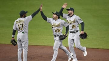BALTIMORE, MARYLAND - APRIL 23: Elvis Andrus #17 of the Oakland Athletics celebrates with his teammates Ramon Laureano #22 and Seth Brown #15 after the Athletics defeated the Baltimore Orioles 3-1 at Oriole Park at Camden Yards on April 23, 2021 in Baltimore, Maryland. (Photo by Patrick McDermott/Getty Images)