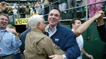 OAKLAND, CA - OCTOBER 06: Owner Lewis Wolff and General Manager Billy Beane of the Oakland Athletics celebrate after the final out of game three of the American League Division Series against the Minnesota Twins at McAfee Coliseum on October 6, 2006 in Oakland, California. (Photo by Sara Wolfram/Getty Images)