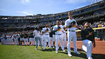OAKLAND, CA - SEPTEMBER 24: Bruce Maxwell #13 of the Oakland Athletics kneels in protest next to teammate Mark Canha #20 duing the singing of the National Anthem prior to the start of the game against the Texas Rangers at Oakland Alameda Coliseum on September 24, 2017 in Oakland, California. (Photo by Thearon W. Henderson/Getty Images)