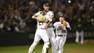 OAKLAND, CA - APRIL 21: Sean Manaea #55, Jonathan Lucroy #21 and Matt Chapman #26 of the Oakland Athletics celebrates after Manaea pitched a no-hitter against the Boston Red Sox at the Oakland Alameda Coliseum on April 21, 2018 in Oakland, California. The Athletics won the game 3-0. (Photo by Thearon W. Henderson/Getty Images)