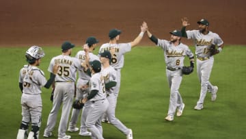 Apr 9, 2021; Houston, Texas, USA; Oakland Athletics second baseman Jed Lowrie (8) celebrates with teammates after defeating the Houston Astros at Minute Maid Park. Mandatory Credit: Troy Taormina-USA TODAY Sports