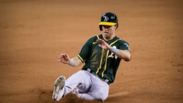 Jun 23, 2021; Arlington, Texas, USA; Oakland Athletics center fielder Skye Bolt (49) slides into third base during the seventh inning against the Texas Rangers at Globe Life Field. Mandatory Credit: Jerome Miron-USA TODAY Sports
