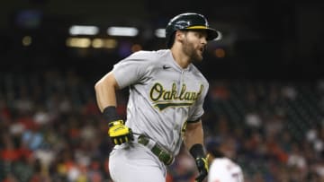 Jul 7, 2021; Houston, Texas, USA; Oakland Athletics third baseman Chad Pinder (4) runs to first base on a double during the fifth inning against the Houston Astros at Minute Maid Park. Mandatory Credit: Troy Taormina-USA TODAY Sports