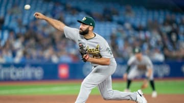 Apr 16, 2022; Toronto, Ontario, CAN; Oakland Athletics relief pitcher Lou Trivino (62) throws a pitch during the ninth inning against the Toronto Blue Jays at Rogers Centre. Mandatory Credit: Nick Turchiaro-USA TODAY Sports