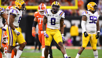 NEW ORLEANS, LA - JANUARY 13: Patrick Queen #8 of the LSU Tigers celebrates a tackle against Travis Etienne #9 of the Clemson Tigers during the College Football Playoff National Championship held at the Mercedes-Benz Superdome on January 13, 2020 in New Orleans, Louisiana. (Photo by Jamie Schwaberow/Getty Images)