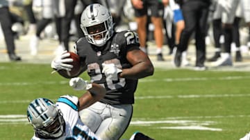 CHARLOTTE, NORTH CAROLINA - SEPTEMBER 13: Juston Burris #31 and Shaq Thompson #54 of the Carolina Panthers attempt to tackle Josh Jacobs #28 of the Las Vegas Raiders during their game at Bank of America Stadium on September 13, 2020 in Charlotte, North Carolina. Las Vegas won 34-30. (Photo by Grant Halverson/Getty Images)