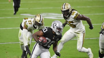 LAS VEGAS, NEVADA - SEPTEMBER 21: Running back Jalen Richard #30 of the Las Vegas Raiders rushes for a 20-yard touchdown against strong safety Malcolm Jenkins #27 and outside linebacker Demario Davis #56 of the New Orleans Saints during the second half of the NFL game at Allegiant Stadium on September 21, 2020 in Las Vegas, Nevada. The Raiders defeated the Saints 34-24. (Photo by Ethan Miller/Getty Images)