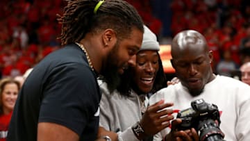 NEW ORLEANS, LA - APRIL 19: New Orleans Saints Players (L-R) Cameron Jordan, Alvin Kamara and Chris Banjo look at a camera while attending Game 3 of the Western Conference playoffs between the Portland Trail Blazers and the New Orleans Pelicans at the Smoothie King Center on April 19, 2018 in New Orleans, Louisiana. NOTE TO USER: User expressly acknowledges and agrees that, by downloading and or using this photograph, User is consenting to the terms and conditions of the Getty Images License Agreement. (Photo by Sean Gardner/Getty Images)