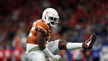 SAN ANTONIO, TX - DECEMBER 31: Malcolm Roach #32 of the Texas Longhorns celebrates a tackle in the second quarter against the Utah Utes during the Valero Alamo Bowl at the Alamodome on December 31, 2019 in San Antonio, Texas. (Photo by Tim Warner/Getty Images)