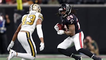 ATLANTA, GA - NOVEMBER 28: Devonta Freeman #24 of the Atlanta Falcons rushes as Marcus Williams #43 of the New Orleans Saints defends during the second half of an NFL game at Mercedes-Benz Stadium on November 28, 2019 in Atlanta, Georgia. (Photo by Todd Kirkland/Getty Images)