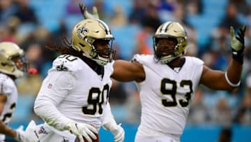 CHARLOTTE, NORTH CAROLINA - DECEMBER 29: Malcom Brown #90 and David Onyemata #93 of the New Orleans Saints celebrate after a fumble recovery during the first quarter during their game against the Carolina Panthers at Bank of America Stadium on December 29, 2019 in Charlotte, North Carolina. (Photo by Jacob Kupferman/Getty Images)
