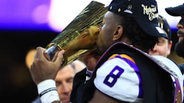 NEW ORLEANS, LOUISIANA - JANUARY 13: Patrick Queen #8 of the LSU Tigers celebrates with the trophy after defeating the Clemson Tigers 42-25 in the College Football Playoff National Championship game at Mercedes Benz Superdome on January 13, 2020 in New Orleans, Louisiana. (Photo by Mike Ehrmann/Getty Images)