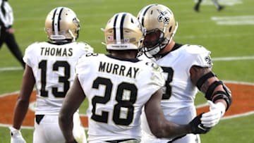 DENVER, COLORADO - NOVEMBER 29: Latavius Murray #28 of the New Orleans Saints celebrates alongside Michael Thomas #13 and Erik McCoy #78 during the third quarter of a game against the Denver Broncos at Empower Field At Mile High on November 29, 2020 in Denver, Colorado. (Photo by Matthew Stockman/Getty Images)