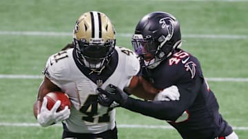 ATLANTA, GEORGIA - DECEMBER 06: Alvin Kamara #41 of the New Orleans Saints attempts to get past Deion Jones #45 of the Atlanta Falcons during the second quarter at Mercedes-Benz Stadium on December 06, 2020 in Atlanta, Georgia. (Photo by Kevin C. Cox/Getty Images)