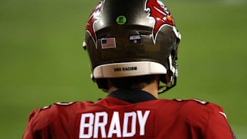 LANDOVER, MARYLAND - JANUARY 09: Quarterback Tom Brady #12 of the Tampa Bay Buccaneers warms up before playing against the Washington Football Team at FedExField on January 09, 2021 in Landover, Maryland. (Photo by Patrick Smith/Getty Images)