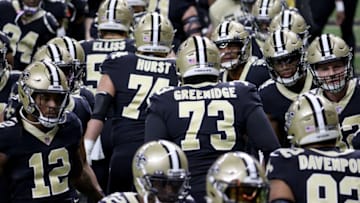 NEW ORLEANS, LOUISIANA - JANUARY 10: James Hurst #74 and Ethan Greenidge #73 of the New Orleans Saints high five their teammates ahead of the NFC Wild Card Playoff game against the Chicago Bears at Mercedes Benz Superdome on January 10, 2021 in New Orleans, Louisiana. (Photo by Chris Graythen/Getty Images)