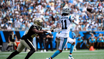 CHARLOTTE, NORTH CAROLINA - SEPTEMBER 19: Wide receiver Robby Anderson #11 of the Carolina Panthers makes a reception over cornerback Paulson Adebo #29 of the New Orleans Saints for a first down during the first quarter of the football game at Bank of America Stadium on September 19, 2021 in Charlotte, North Carolina. (Photo by Mike Comer/Getty Images)