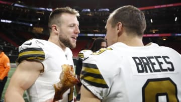 ATLANTA, GA - NOVEMBER 28: Taysom Hill #7 of the New Orleans Saints celebrates the victory with Drew Brees #9 while eating turkey legs following an NFL game against the Atlanta Falcons at Mercedes-Benz Stadium on November 28, 2019 in Atlanta, Georgia. (Photo by Todd Kirkland/Getty Images)
