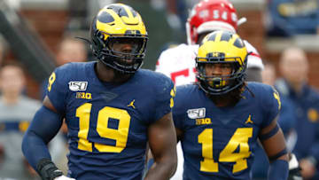 Sep 28, 2019; Ann Arbor, MI, USA; Michigan Wolverines defensive lineman Kwity Paye (19) and defensive back Josh Metellus (14) react after a play during the first quarter against the Rutgers Scarlet Knights at Michigan Stadium. Mandatory Credit: Raj Mehta-USA TODAY Sports