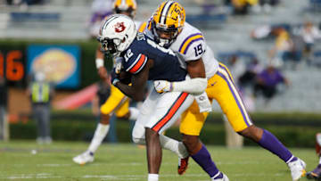 Oct 31, 2020; Auburn, Alabama, USA; Auburn Tigers receiver Eli Stove (12) is tackled by LSU Tigers linebacker Jabril Cox (21) during the second quarter at Jordan-Hare Stadium. Mandatory Credit: John Reed-USA TODAY Sports