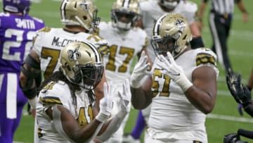 Dec 25, 2020; New Orleans, Louisiana, USA; New Orleans Saints running back Alvin Kamara (41) gestures with offensive guard Cesar Ruiz (51) after scoring his fourth touchdown of the game in the second half against the Minnesota Vikings at the Mercedes-Benz Superdome. Mandatory Credit: Chuck Cook-USA TODAY Sports