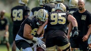 Jul 31, 2021; Metairie, LA, USA; New Orleans Saints defensive tackle Ryan Glasgow (95) and defensive tackle Lorenzo Neal (69) perform defensive line drills during a New Orleans Saints training camp session at the New Orleans Saints Training Facility. Mandatory Credit: Stephen Lew-USA TODAY Sports