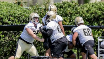 New Orleans Saints offensive guard Eric Wilson (65) rushes offensive tackle Khalique Washington (63) -Mandatory Credit: Stephen Lew-USA TODAY Sports