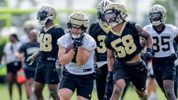 New Orleans Saints linebacker Eric Wilson (58) attempts to punch the ball from quarterback Taysom Hill (7) - Mandatory Credit: Stephen Lew-USA TODAY Sports