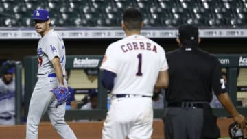 HOUSTON, TEXAS - JULY 28: Joe Kelly #17 of the Los Angeles Dodgers has a word with Carlos Correa #1 of the Houston Astros as he walks off the mound after a series of high inside pitches in the sixth inning at Minute Maid Park on July 28, 2020 in Houston, Texas. Both benches emptied. (Photo by Bob Levey/Getty Images)