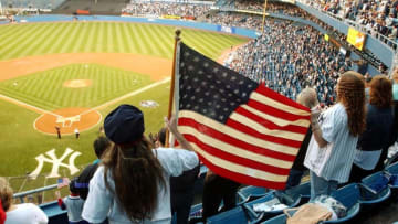 Fans wave an American flag during pre-game ceremonies at Yankee Stadium for 9/11 (HENNY RAY ABRAMS/AFP via Getty Images)