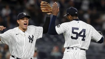 NEW YORK, NEW YORK - MAY 21: (NEW YORK DAILIES OUT) Gio Urshela #29 and Aroldis Chapman #54 of the New York Yankees react after a ninth inning triple play against the Chicago White Sox at Yankee Stadium on May 21, 2021 in New York City. The Yankees defeated the White Sox 2-1. (Photo by Jim McIsaac/Getty Images)