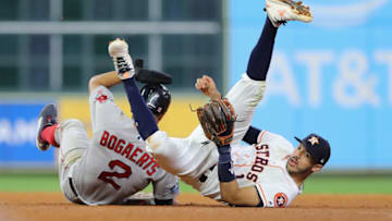 HOUSTON, TX - OCTOBER 17: Carlos Correa #1 of the Houston Astros collides with Xander Bogaerts #2 of the Boston Red Sox at second base during a double play attempt in the seventh inning during Game Four of the American League Championship Series at Minute Maid Park on October 17, 2018 in Houston, Texas. (Photo by Elsa/Getty Images)