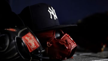 NEW YORK, NY - JUNE 6: A New York Yankees baseball hat sits on top of a glove in the Yankee dugout against the Boston Red Sox during the eighth inning at Yankee Stadium on June 6, 2021 in the Bronx borough of New York City. (Photo by Adam Hunger/Getty Images)