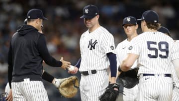 NEW YORK, NEW YORK - SEPTEMBER 22: Corey Kluber #28 of the New York Yankees hands the ball to manager Aaron Boone as he is removed from a game against the Texas Rangers in the fifth inning at Yankee Stadium on September 22, 2021 in New York City. (Photo by Jim McIsaac/Getty Images)