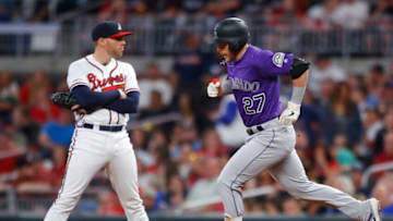 ATLANTA, GA - APRIL 27: Trevor Story #27 of the Colorado Rockies rounds first after hitting a three run home run as Freddie Freeman #5 of the Atlanta Braves reacts in the ninth inning of an MLB game at SunTrust Park on April 27, 2019 in Atlanta, Georgia. (Photo by Todd Kirkland/Getty Images)