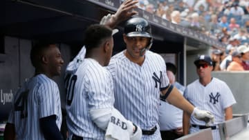 NEW YORK, NY - AUGUST 18: Giancarlo Stanton #27 of the New York Yankees celebrates his fourth inning home run against the Toronto Blue Jays with teammate Luis Severino #40 in the dugout at Yankee Stadium on August 18, 2018 in the Bronx borough of New York City. (Photo by Jim McIsaac/Getty Images)