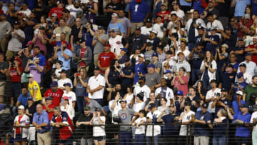 ARLINGTON, TX - OCTOBER 4: Baseball fans stand in the outfield before Aaron Judge #99 of the New York Yankees bats against the Texas Rangers in the ninth inning in game one of a double header at Globe Life Field on October 4, 2022 in Arlington, Texas. (Photo by Ron Jenkins/Getty Images)