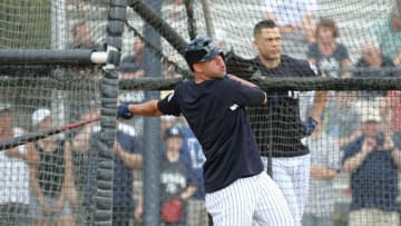 Feb 20, 2018; Tampa, FL, USA; New York Yankees catcher Gary Sanchez (24) hits during batting practice as right fielder Giancarlo Stanton (27) looks on at George M. Steinbrenner Field. Mandatory Credit: Kim Klement-USA TODAY Sports
