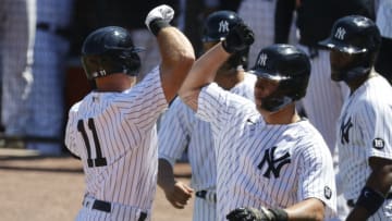Mar 7, 2021; Tampa, Florida, USA; New York Yankees outfielder Brett Gardner (11) is congratulated by catcher Gary Sanchez (24) and teammates after hitting a grand slam against the Philadelphia Phillies at George M. Steinbrenner Field. Mandatory Credit: Kim Klement-USA TODAY Sports