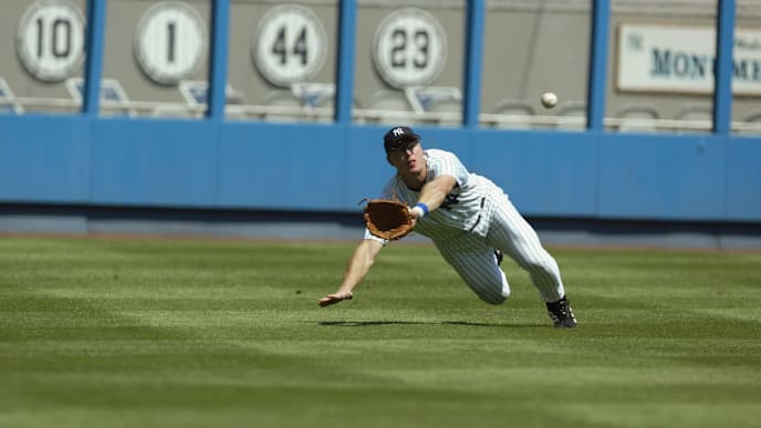 BRONX, NY - AUGUST 21: Leftfielder Shane Spencer #47 of the New York Yankees looks to make a diving catch of the ball off of the bat of leftfielder Garret Anderson #16 of the Anaheim Angels during the game at Yankee Stadium in the Bronx, New York on August 21, 2002. The Angels defeated the Yankees 5-1. (Photo by Al Bello/Getty Images) BRONX, NY - AUGUST 21: Leftfielder Shane Spencer #47 of the New York Yankees looks to make a diving catch of the ball off of the bat of leftfielder Garret Anderson #16 of the Anaheim Angels during the game at Yankee Stadium in the Bronx, New York on August 21, 2002. The Angels defeated the Yankees 5-1. (Photo by Al Bello/Getty Images)